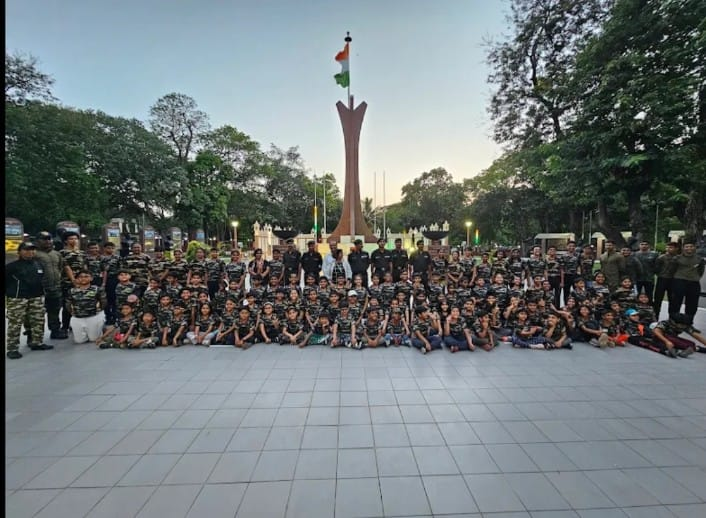 Kids at war memorial with army trainers