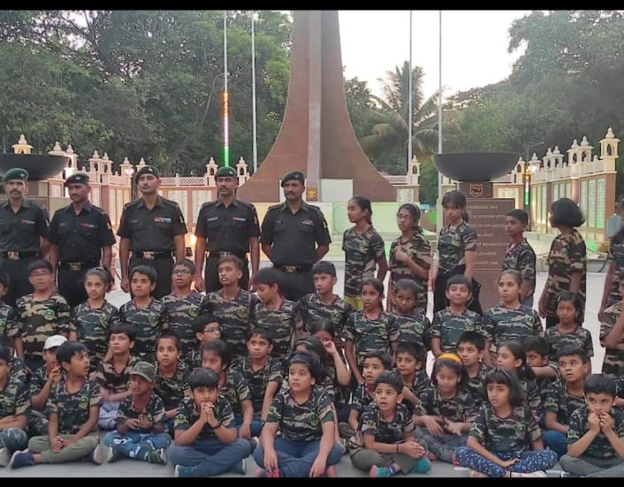 Kids with army officers at memorial